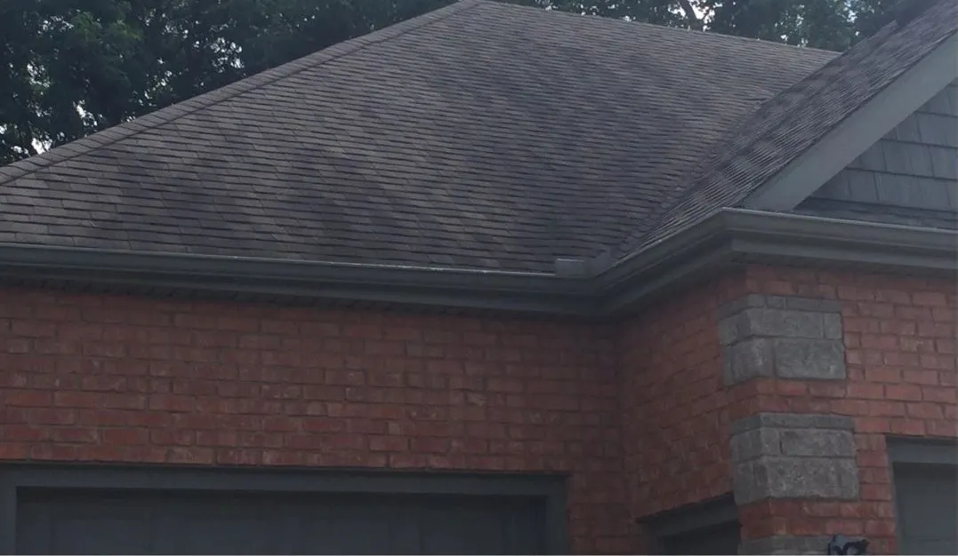 Shingle roof over brick before cleaning