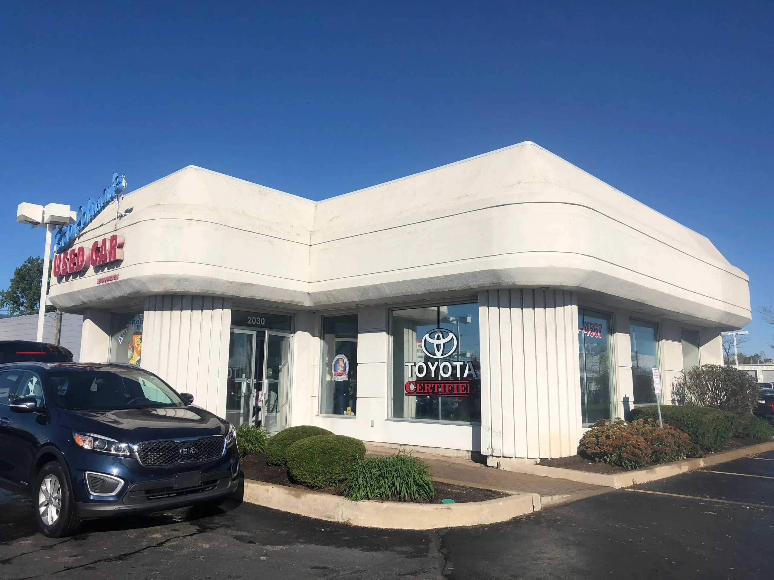 Clean white exterior of an auto dealership