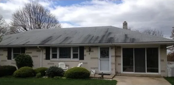 Single story home roof before cleaning