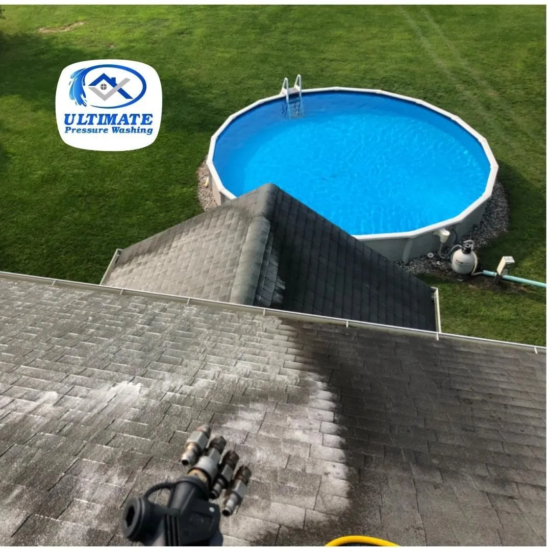 Soft wash nozzle cleaning a shingle roof, with the cleaned section visibly lighter